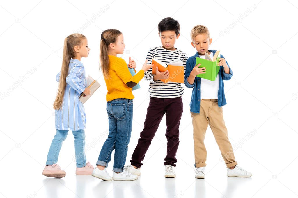 Multiethnic kids holding colorful books on white background 