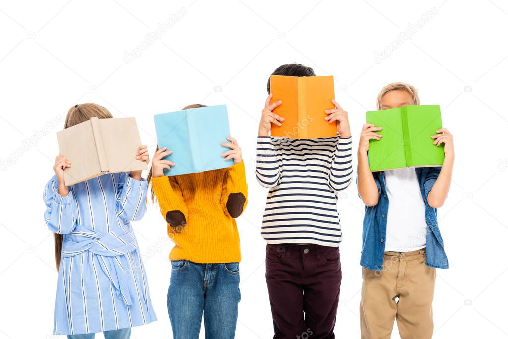 Kids covering faces with colorful books isolated on white