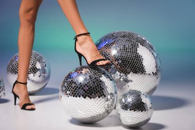 female legs in black shoes on disco ball clipart