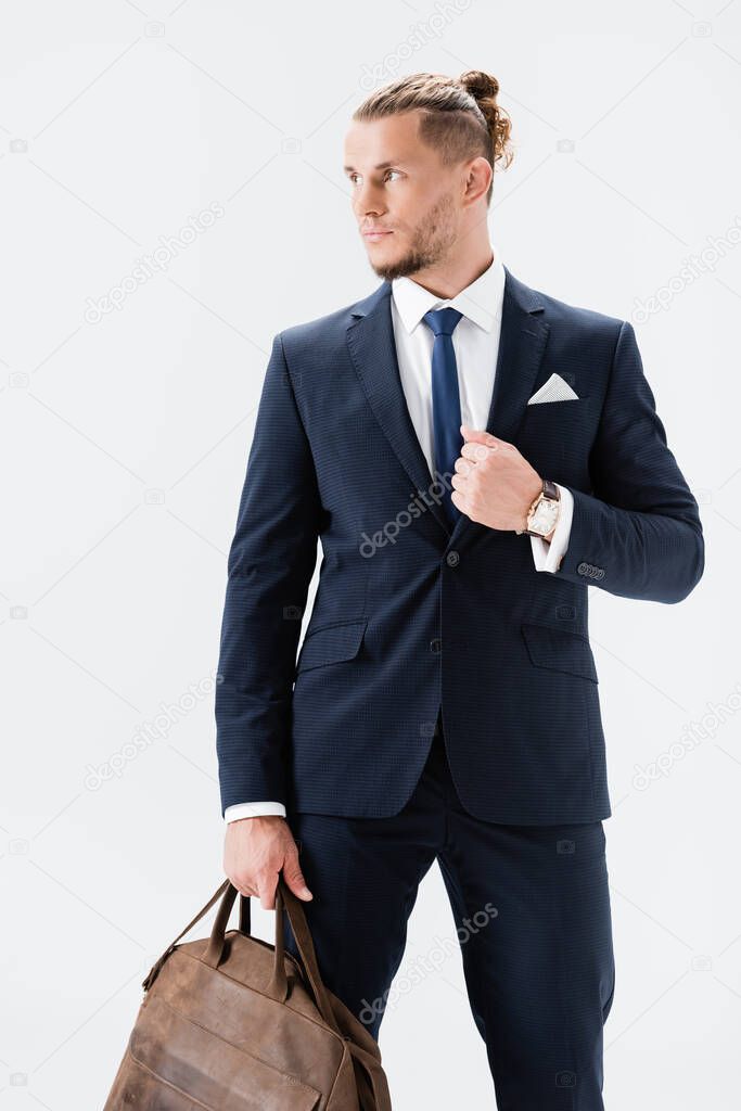 young businessman in suit with suitcase isolated on white