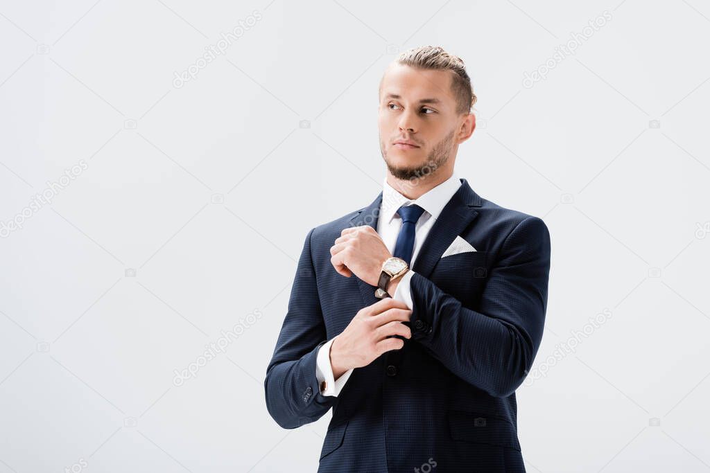 young businessman in suit posing isolated on white