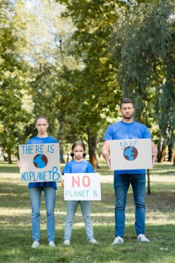 family of volunteers holding placards with there is no planet b inscription, ecology concept clipart