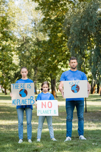 family of volunteers holding placards with there is no planet b inscription, ecology concept