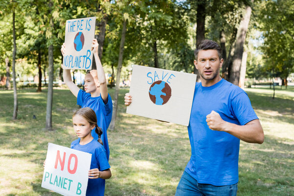 family of volunteers holding placards with globe and there is no planet b inscription, ecology concept