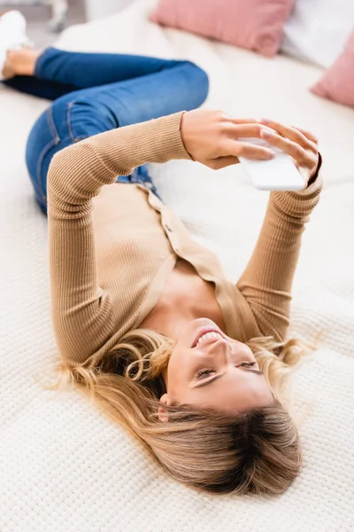 Mulher Sorridente Usando Smartphone Cama Casa — Fotografia de Stock