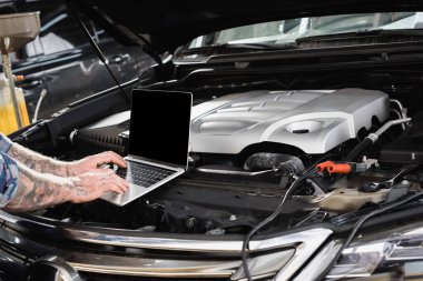 partial view of repairman making diagnostic of car engine compartment clipart