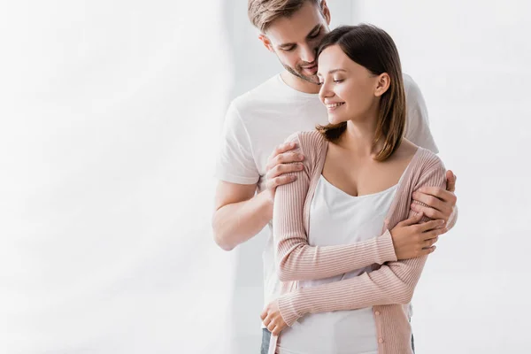 Happy Man Smiling While Hugging Cheerful Wife Home — Stock Photo, Image