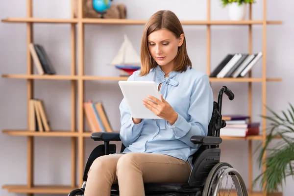 Female Psychologist Using Digital Tablet While Sitting Wheelchair Blurred Office — Stock Photo, Image