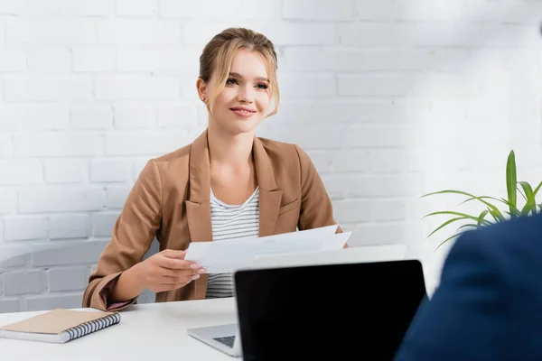 Smiling Businesswoman Documents Looking Worker While Sitting Table Laptops Blurred — Stock Photo, Image