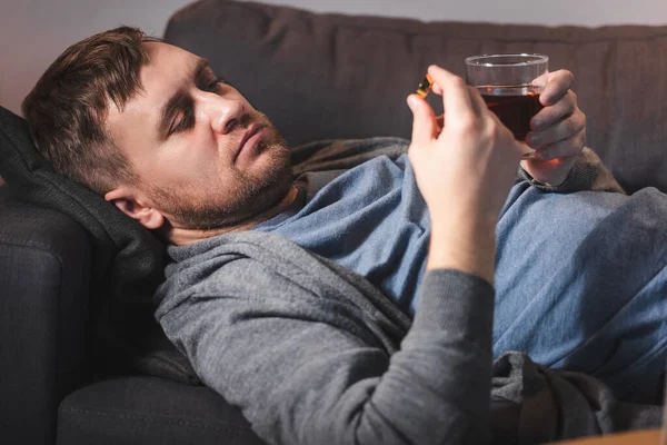 Depressed Man Holding Wedding Ring Glass Whiskey While Lying Sofa — Stock Photo, Image