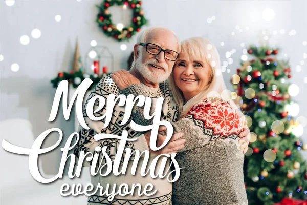 Happy Senior Couple Embracing While Looking Camera Merry Christmas Everyone — Stock Photo, Image