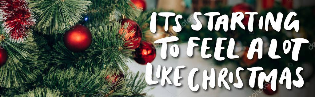 Decorated pine branches with red balls near it is starting to feel a lot like christmas lettering, banner — Stock Image Decorated Pine Branches Red Balls Starting Feel Lot Christmas Lettering Royalty Free Stock Images