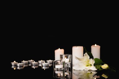 lily, candles on black background, funeral concept clipart