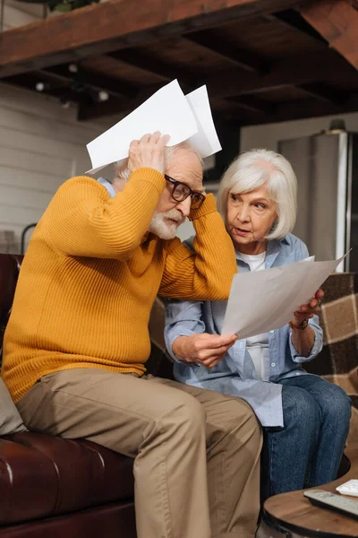 Worried Senior Husband Holding Bills Head Sitting Wife Couch Blurred — Stock Photo, Image