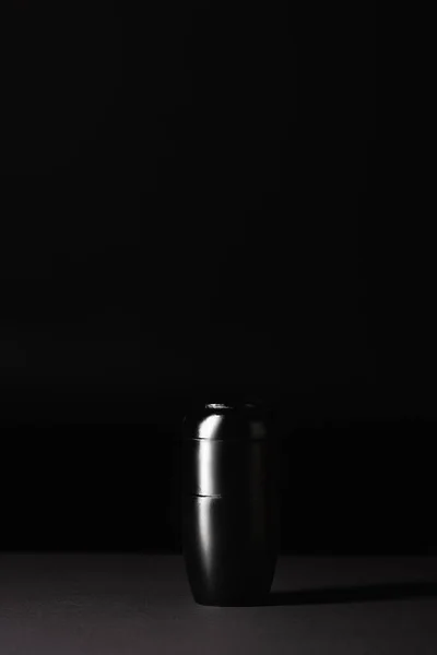 urn with ashes on black background, funeral concept