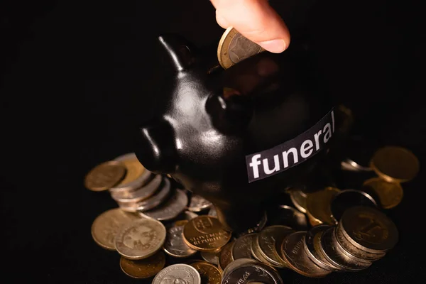Cropped View Man Putting Coin Piggy Bank Black Background Funeral — Stock Photo, Image
