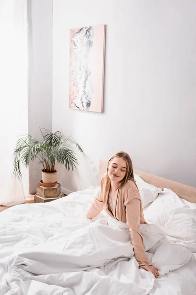 Pleased Young Woman Closed Eyes Sitting Bed Modern Bedroom — Stock Photo, Image