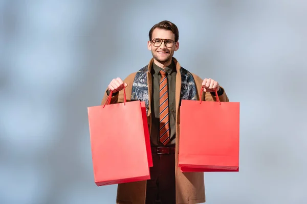 Happy Customer Glasses Holding Paper Bags Grey — Stock Photo, Image