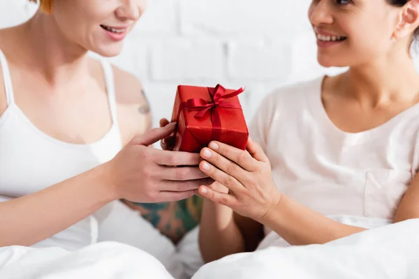 Cropped View African American Woman Presenting Gift Lesbian Girlfriend Bedroom — Stock Photo, Image