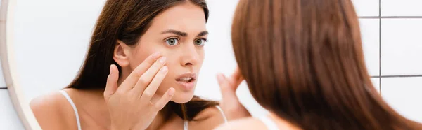 Worried Young Woman Touching Face While Looking Mirror Blurred Foreground — Stock Photo, Image