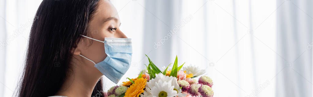 side view of allergic woman in medical mask with flowers at home, banner