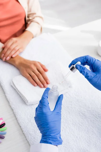 Cropped View Manicurist Holding Cuticle Remover Client Blurred Background — Stock Photo, Image