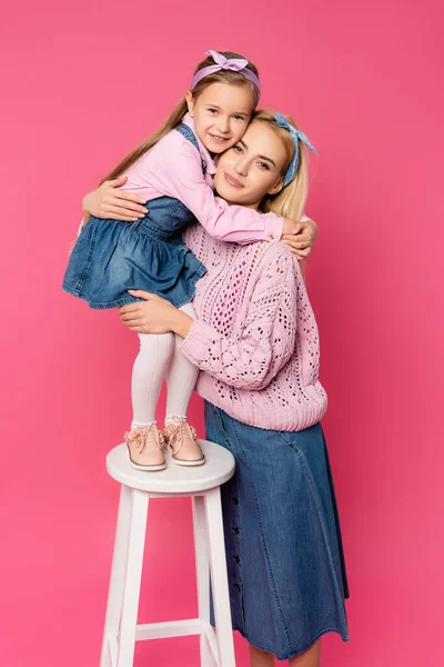 Happy Kid Standing Chair Hugging Mother Pink — Stock Photo, Image