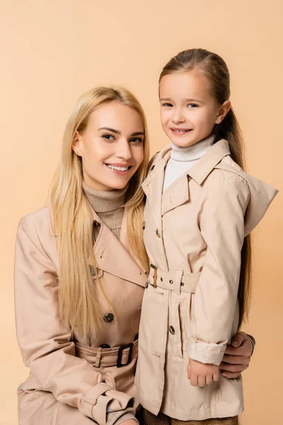 Joyful Mother Daughter Trench Coats Looking Camera Isolated Beige — Stock Photo, Image