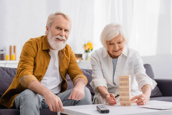 Smiling Senior Couple Playing Blocks Wood Tower Game Coffee Table — Stock Photo, Image