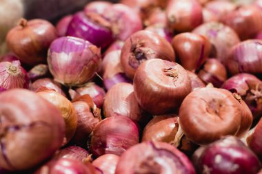 Close up view of organic onions in supermarket  clipart
