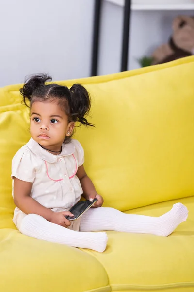 Toddler African American Kid Holding Smartphone While Sitting Sofa — Stock Photo, Image