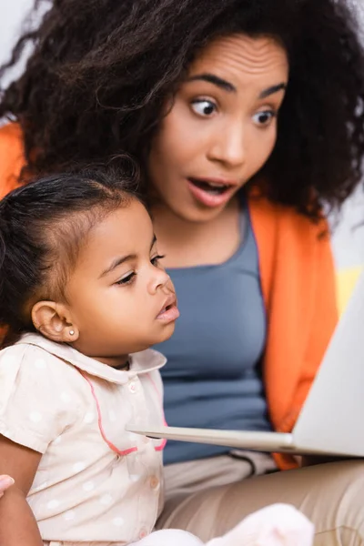 Freelancer Afro Americano Espantado Usando Laptop Perto Filha Criança Sala — Fotografia de Stock