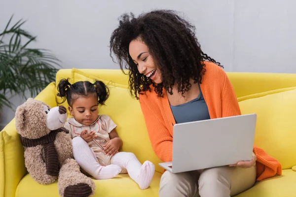 Happy Freelancer Mother Looking African American Daughter Playing Soft Toy — Stock Photo, Image