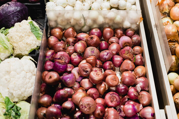 High angle view of onions and cauliflowers in supermarket 