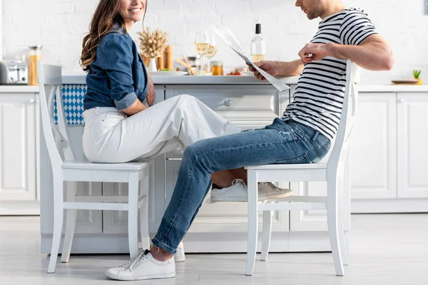 Cropped View Man Sitting Chair Reading Newspaper Cheerful Woman — Stock Photo, Image
