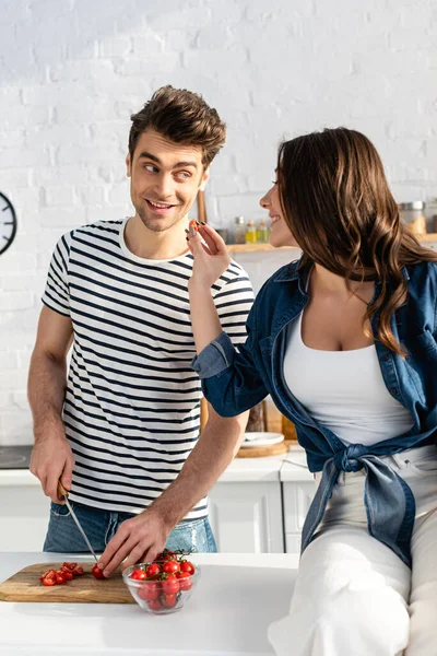 Happy Man Cutting Cherry Tomatoes Chopping Board Looking Smiling Woman — Stock Photo, Image