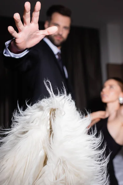 Man Suit Throwing Fluffy Jacket Girlfriend Blurred Background Hotel — Stock Photo, Image