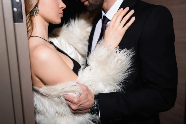 Cropped View Woman Fluffy Jacket Hugging Boyfriend Suit Hotel Night — Stock Photo, Image