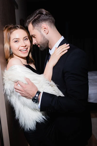 Smiling Woman Fluffy Jacket Hugging Boyfriend Hotel Night — Stock Photo, Image