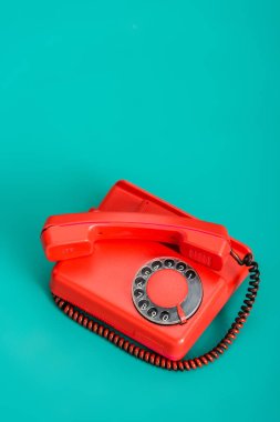 vintage landline phone on turquoise background clipart