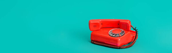 retro landline telephone on turquoise background with copy space, banner