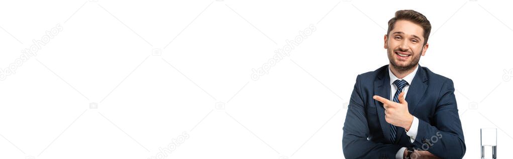 happy anchorman pointing aside with finger while looking at camera isolated on white, banner