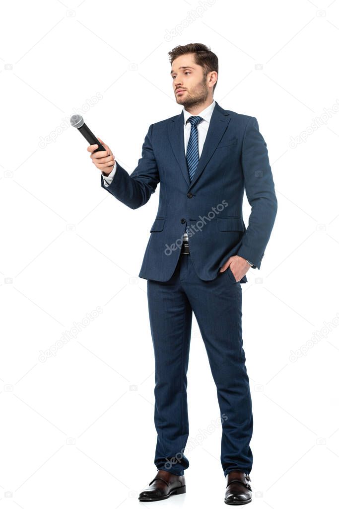 full length view of news anchor holding hand in pocket while standing with microphone on white