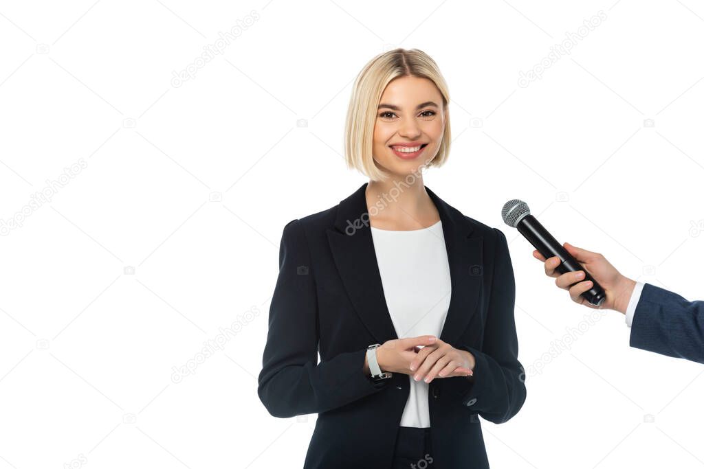 journalist with microphone interviewing successful businesswoman isolated on white