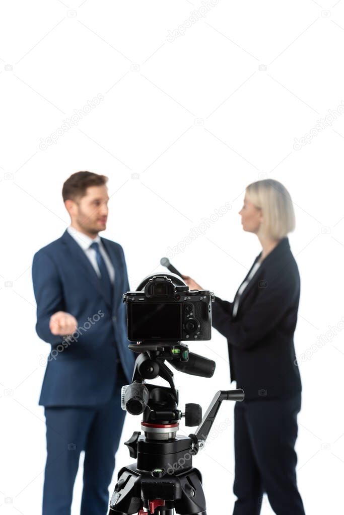 selective focus of digital camera near reporter and businessman on blurred background isolated on white