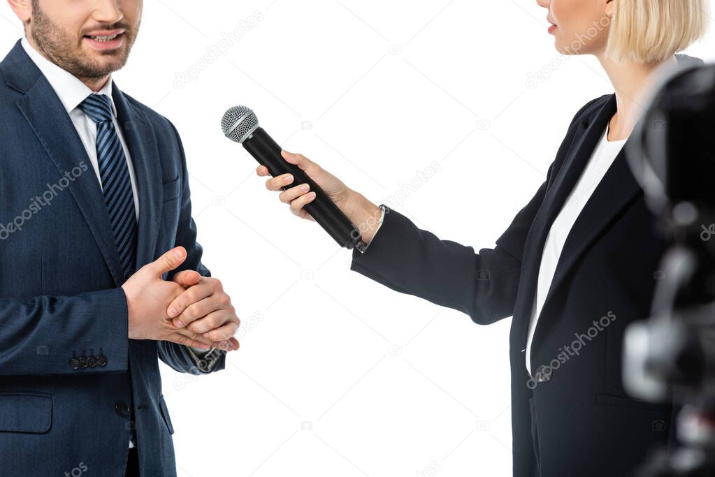 partial view of news presenter taking interview from businessman isolated on white, blurred foreground