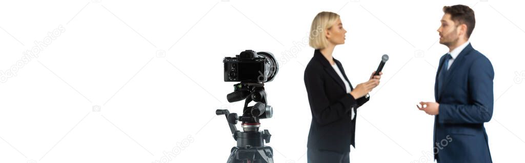 side view of blonde journalist interviewing young businessman isolated on white, blurred background, banner