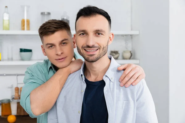 Cheerful Same Sex Couple Looking Camera Kitchen — Stock Photo, Image