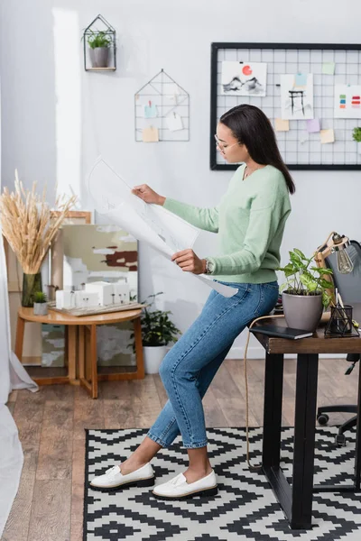 African American Architect Looking Blueprint While Leaning Work Desk Home — Stock Photo, Image