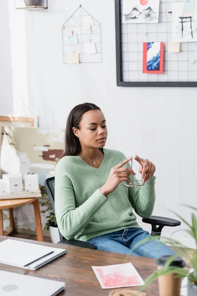 Thoughtful African American Architect Holding Eyeglasses While Sitting Home Studio — Stock Photo, Image